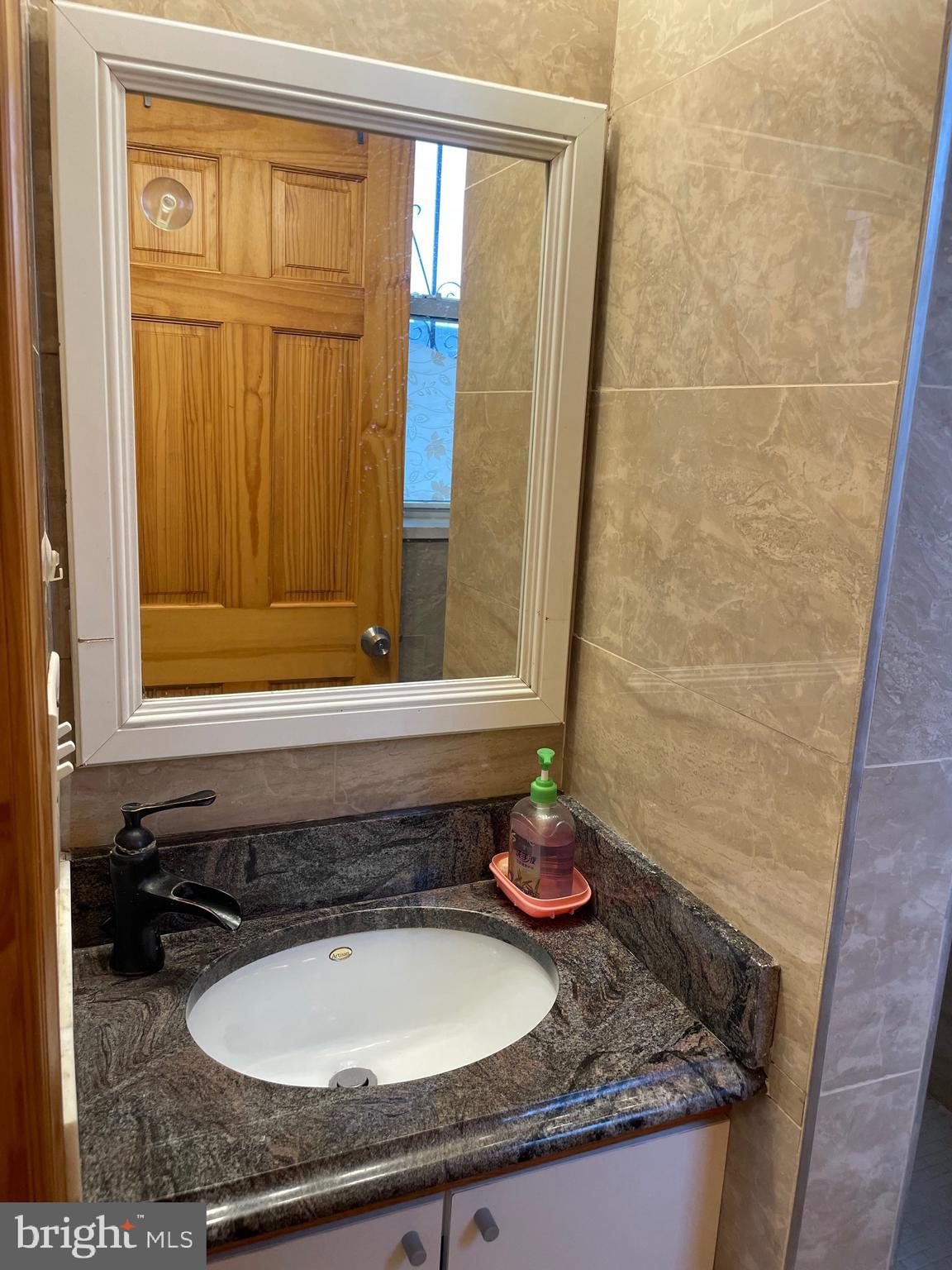 813 Federal Street Philadelphia, PA 19147 - Photo 13 of 28 a bathroom with a granite countertop sink and a mirror