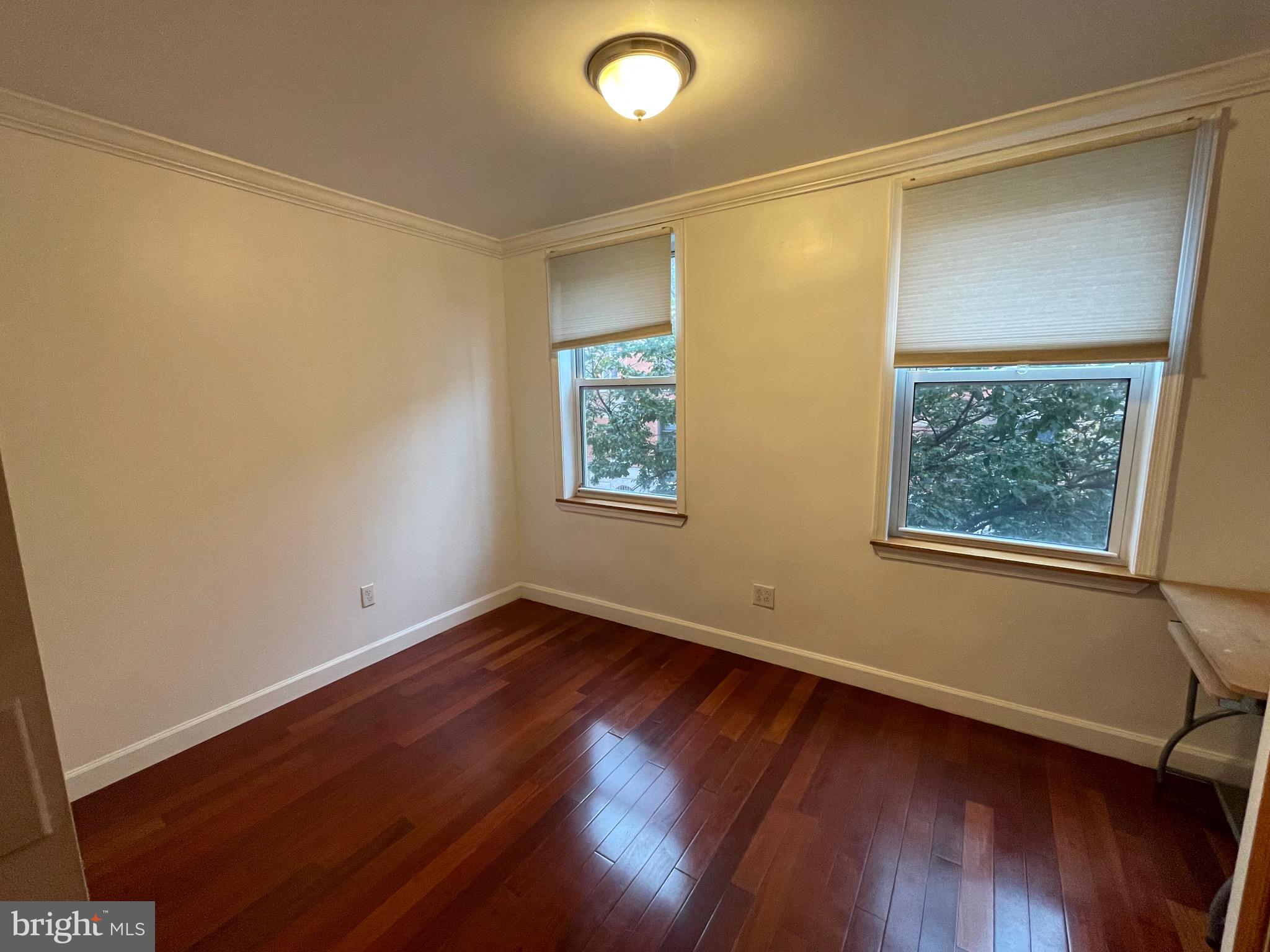 813 Federal Street Philadelphia, PA 19147 - Photo 20 of 28 a view of an empty room with wooden floor and a window