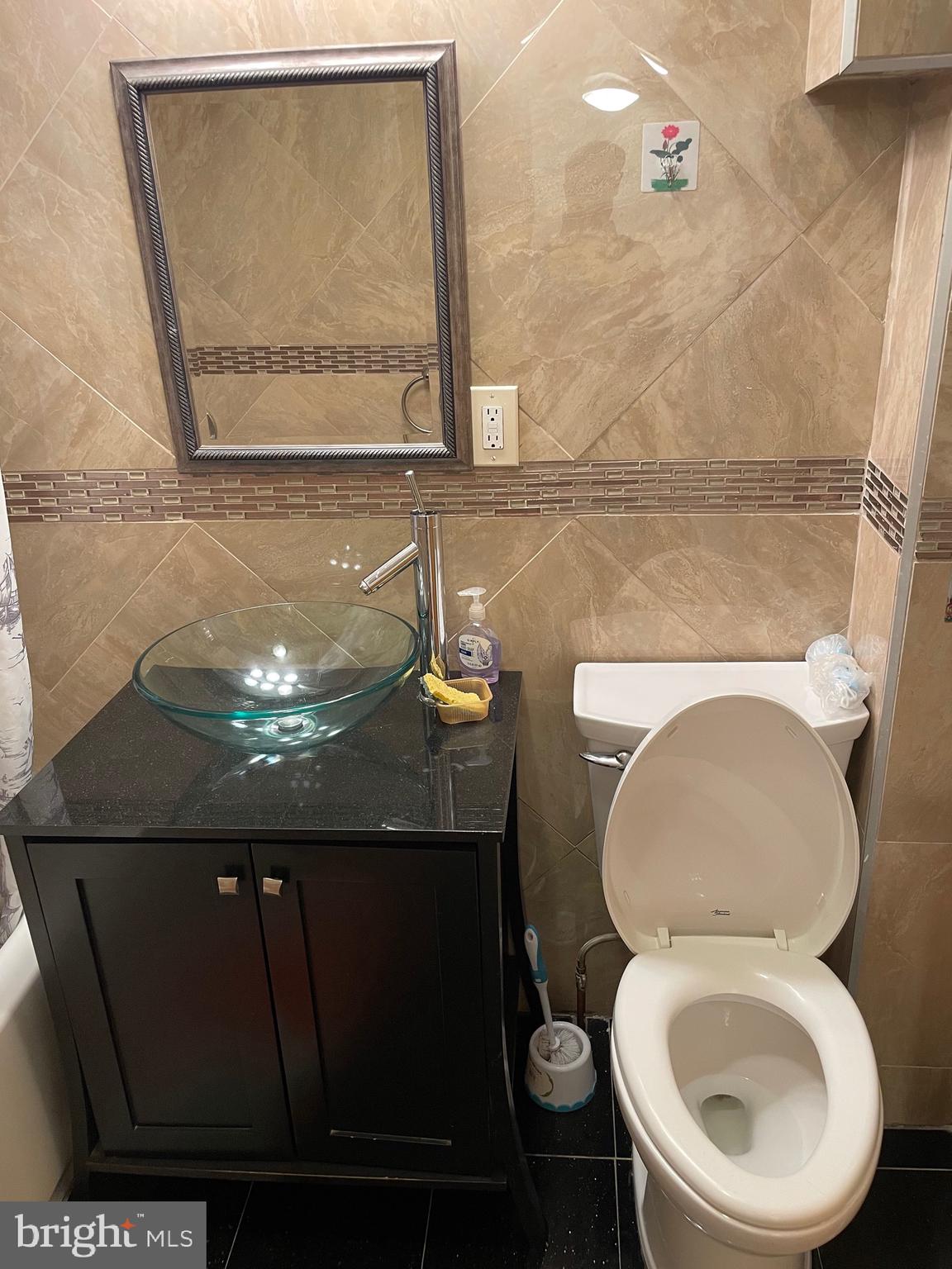813 Federal Street Philadelphia, PA 19147 - Photo 22 of 28 a bathroom with a granite countertop toilet and a sink