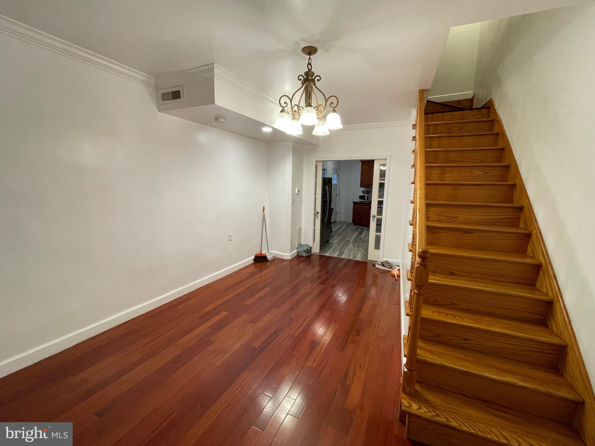 813 Federal Street Philadelphia, PA 19147 - Photo 5 of 28 wooden floor in an empty room with a chandelier