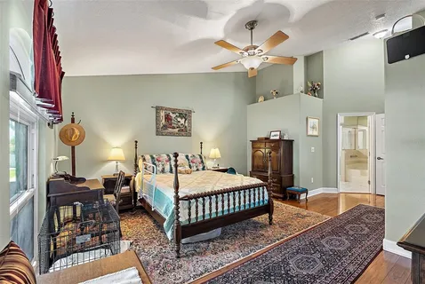 a bedroom with a bed dresser and window