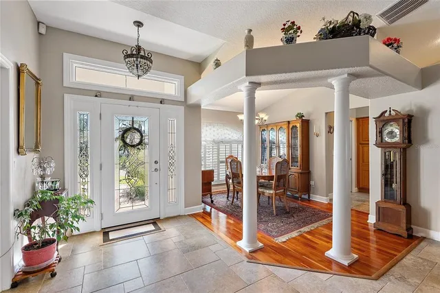 a view of an entryway with a chandelier and living room