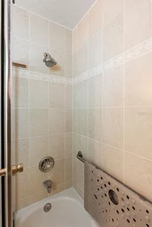 a bathroom with a bathtub and shower