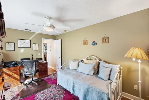 a bedroom with a bed a table and chair