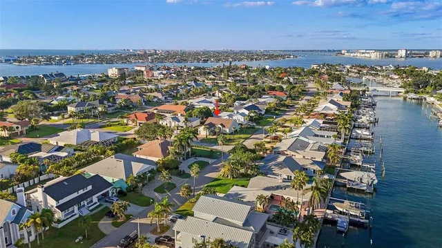 an aerial view of a city with lots of residential buildings and ocean view