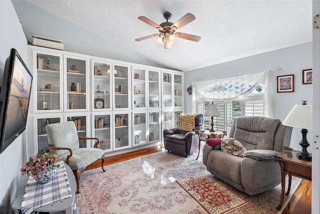 a living room with furniture ceiling fan and a window