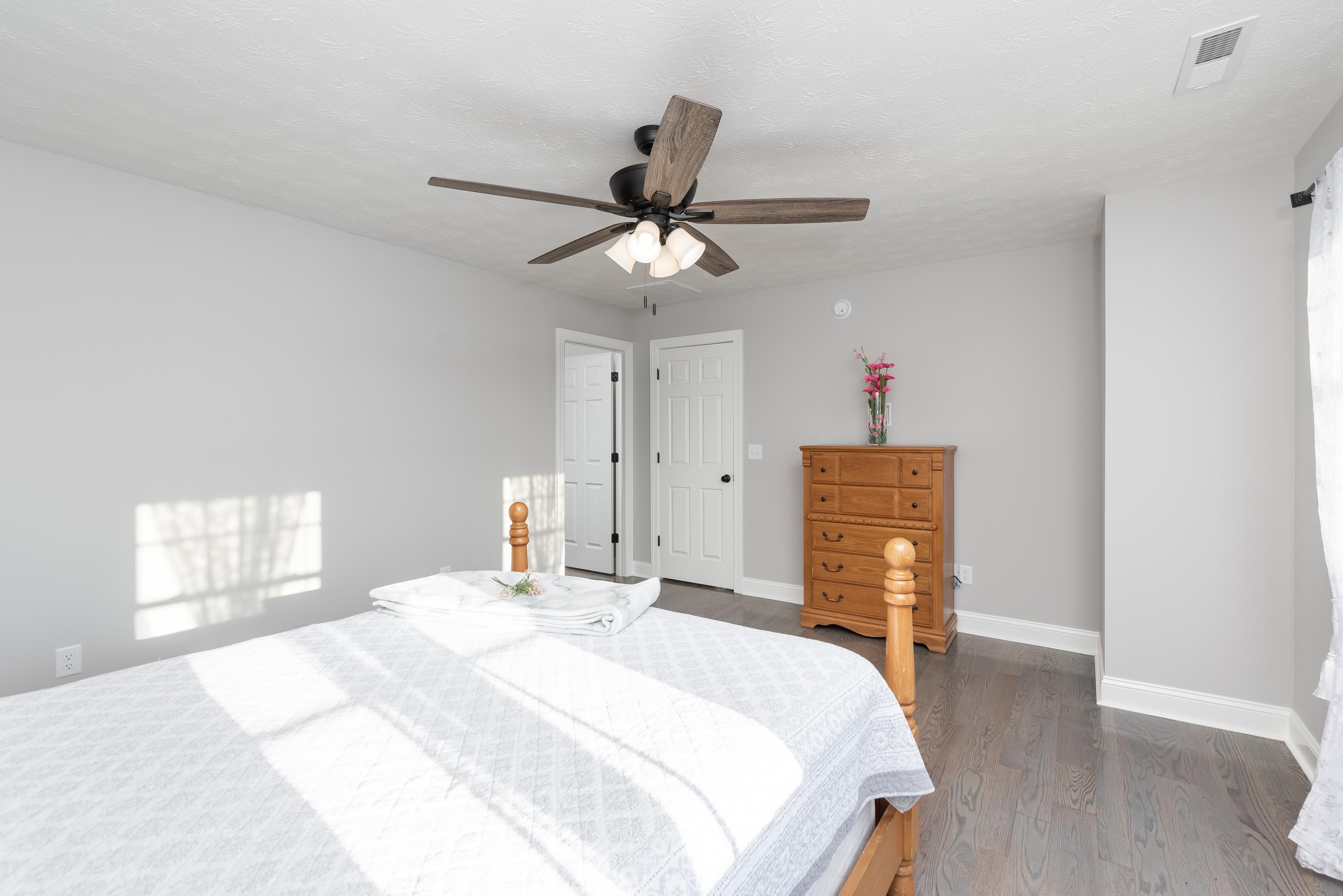 1261 Newport Road Raphine, VA 24472 - Photo 56 of 74 a bedroom with a bed and a chandelier