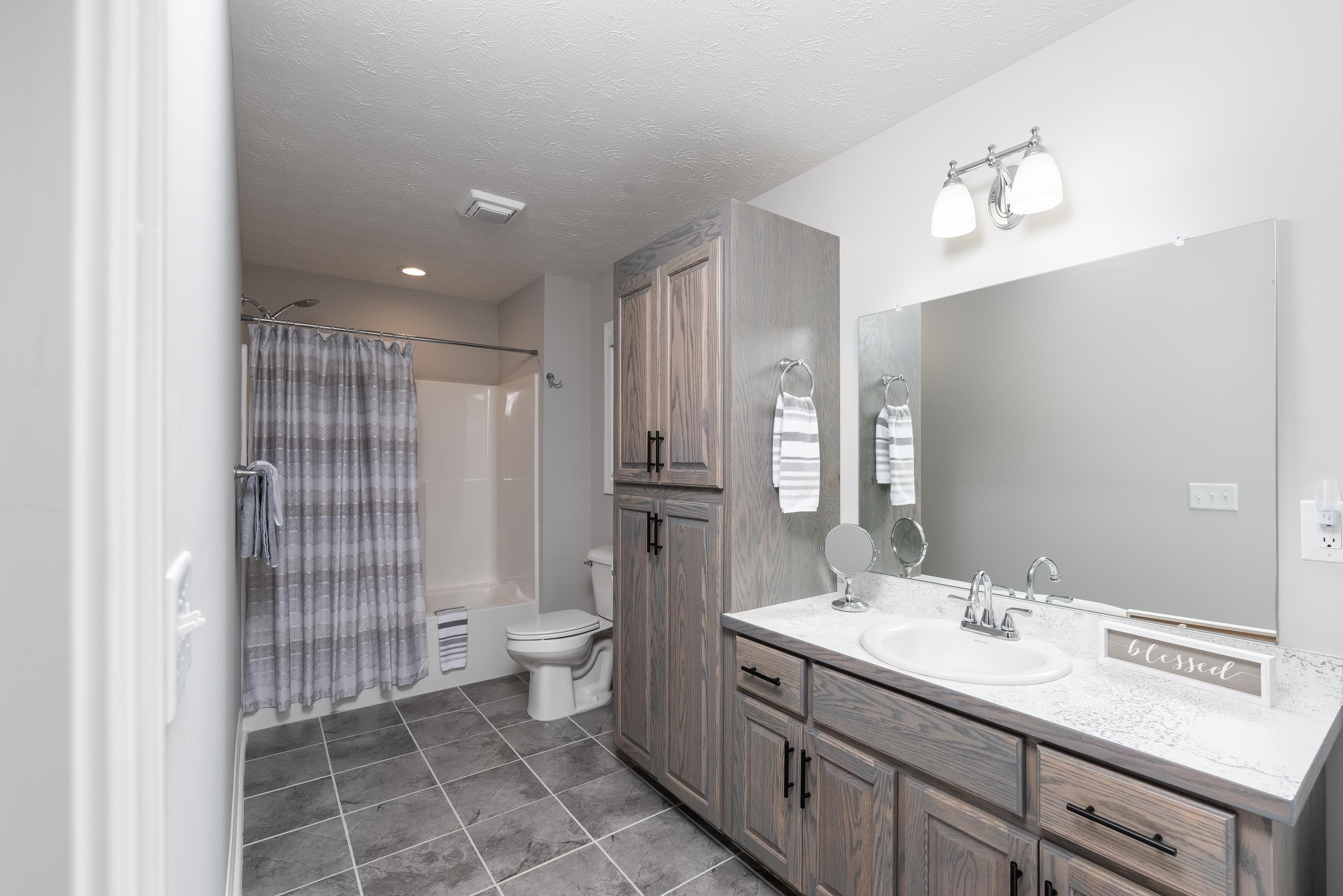 1261 Newport Road Raphine, VA 24472 - Photo 57 of 74 a bathroom with a double vanity sink a toilet and a mirror
