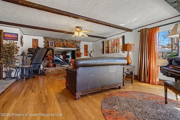 a living room with furniture and a wooden floor