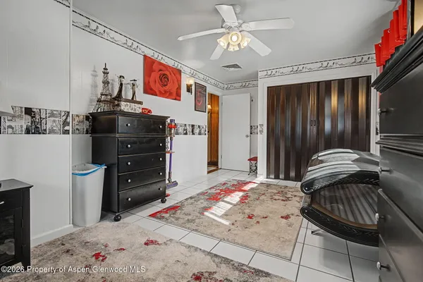 a bedroom with furniture and a flat screen tv