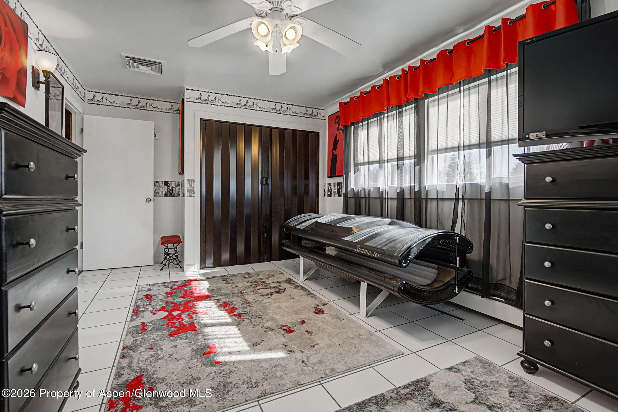 825 Cleveland Street Meeker, CO 81641 - Photo 17 of 41 a bedroom with furniture and a flat screen tv