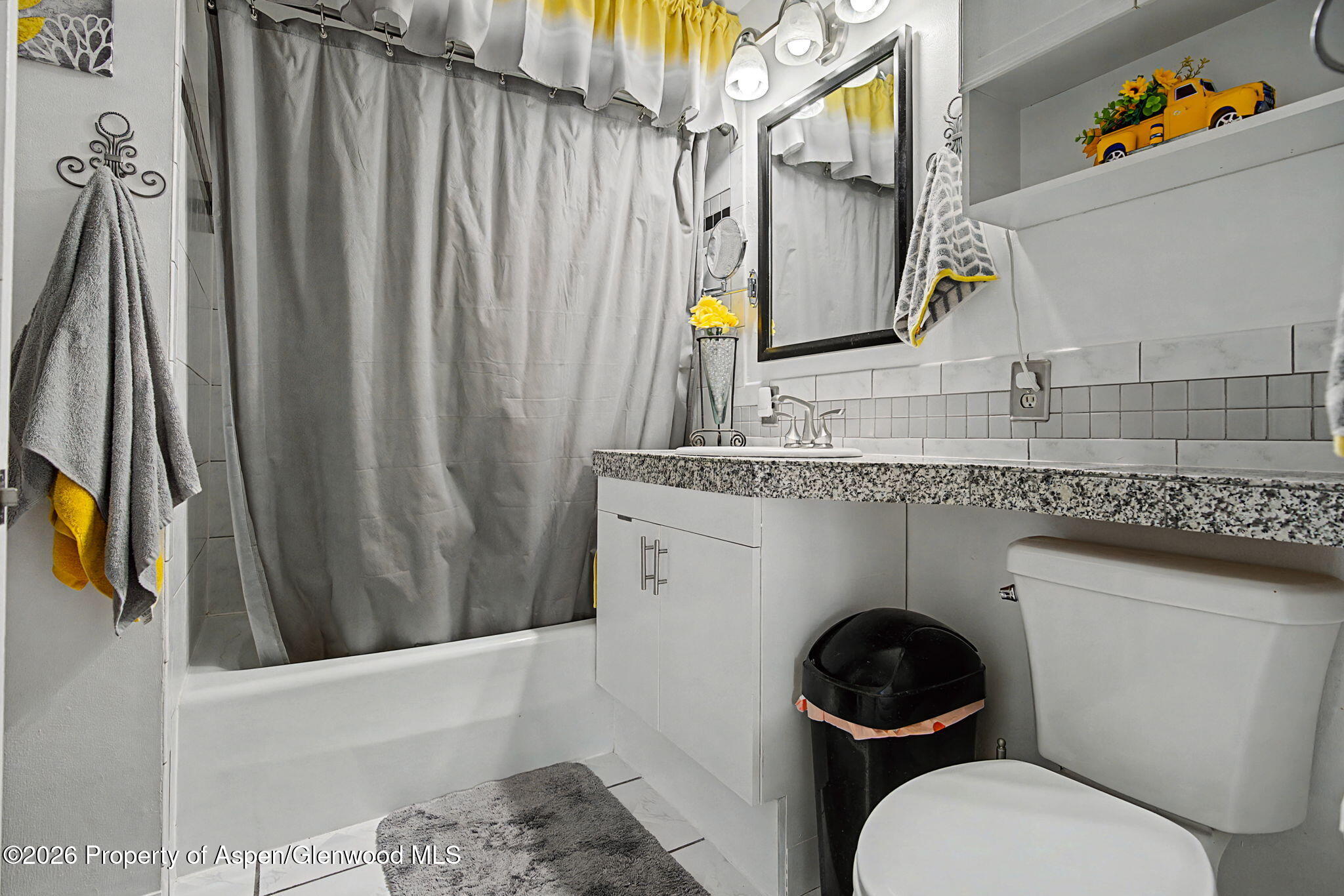 825 Cleveland Street Meeker, CO 81641 - Photo 18 of 41 a bathroom with a granite countertop toilet and a sink