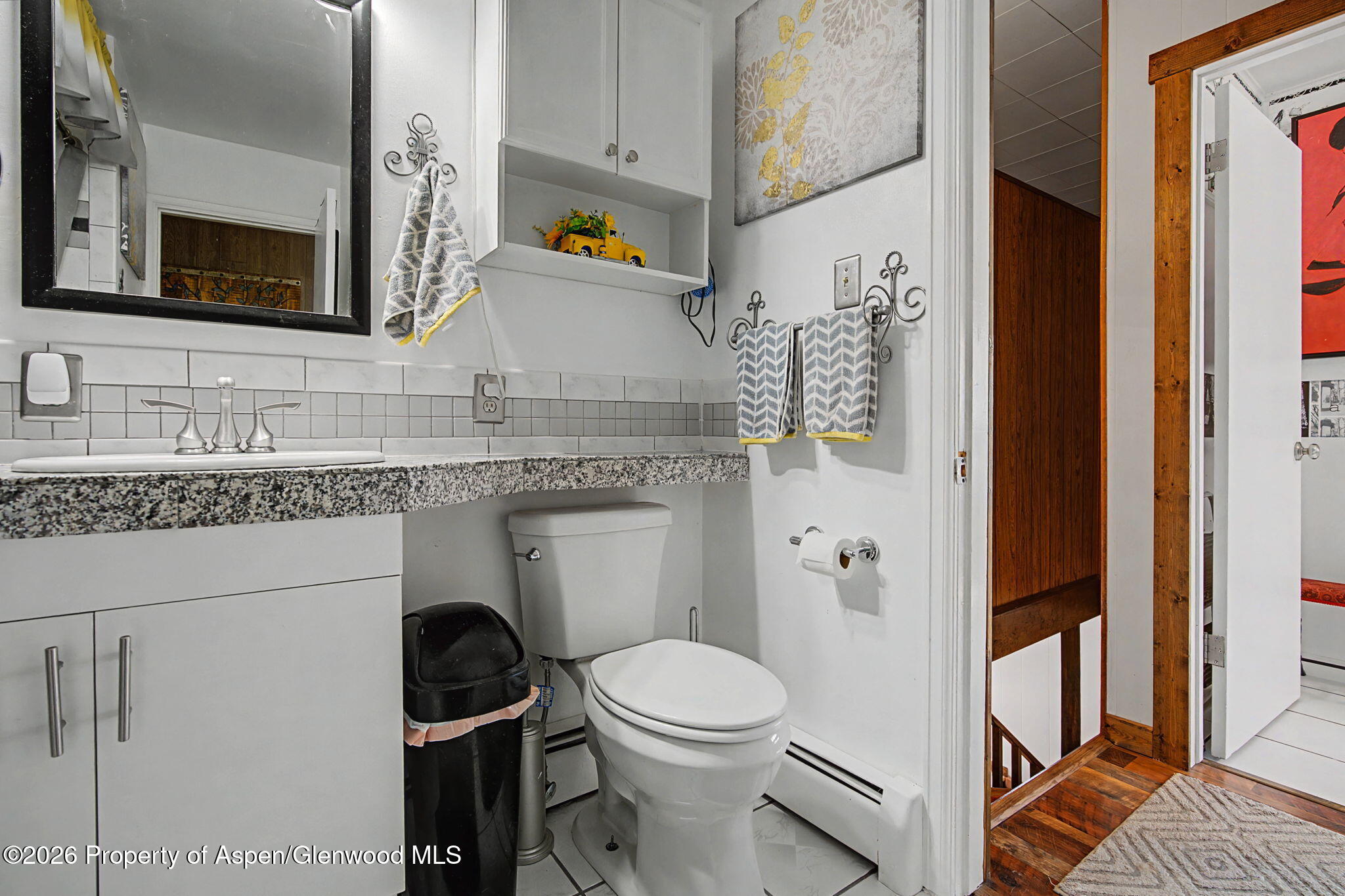 825 Cleveland Street Meeker, CO 81641 - Photo 19 of 41 a bathroom with a granite countertop toilet sink and mirror