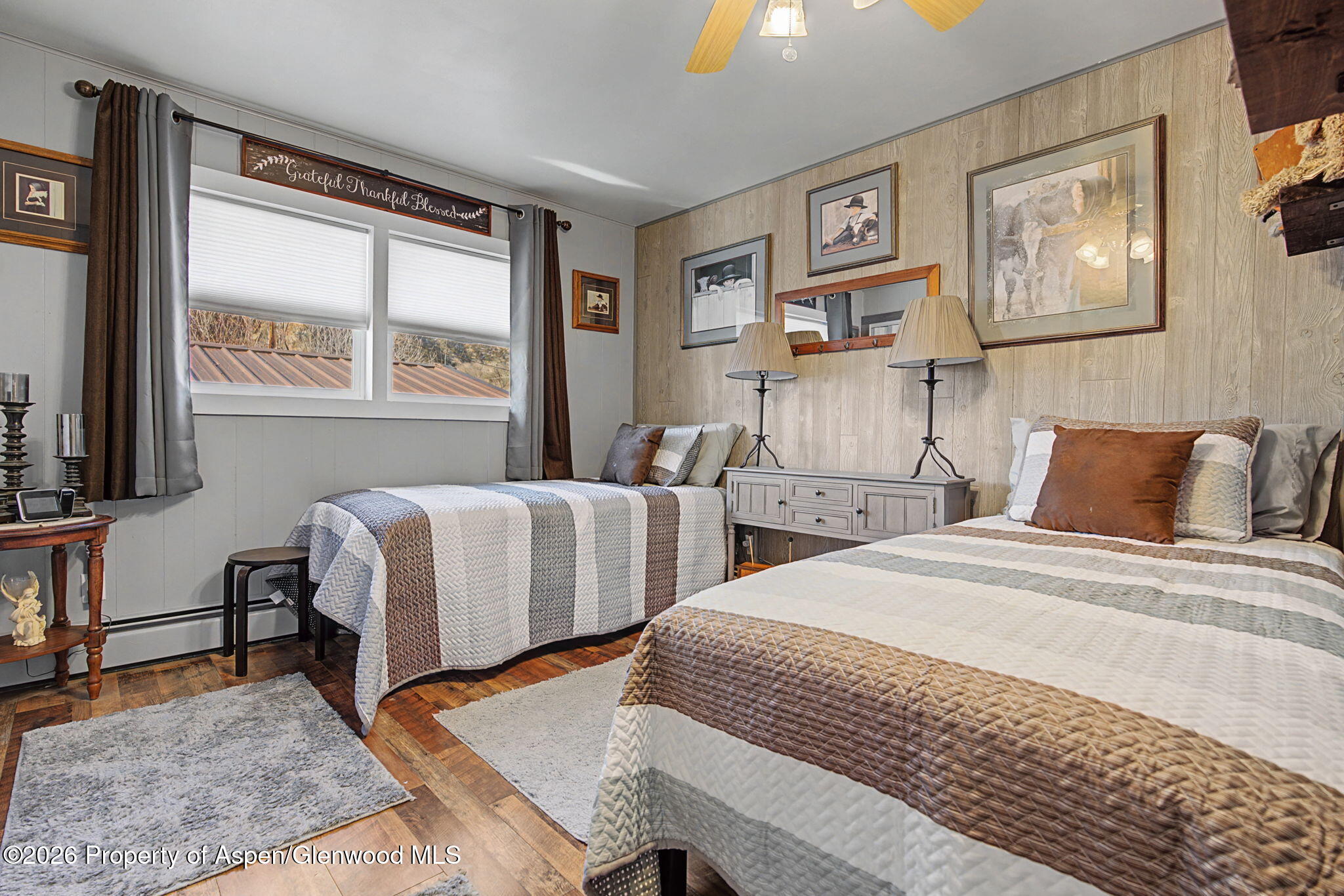 825 Cleveland Street Meeker, CO 81641 - Photo 20 of 41 a bedroom with two beds and a large window