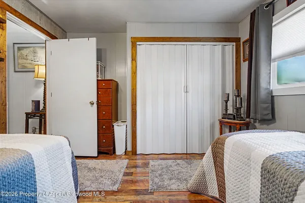 a spacious bedroom with a bed and a chandelier
