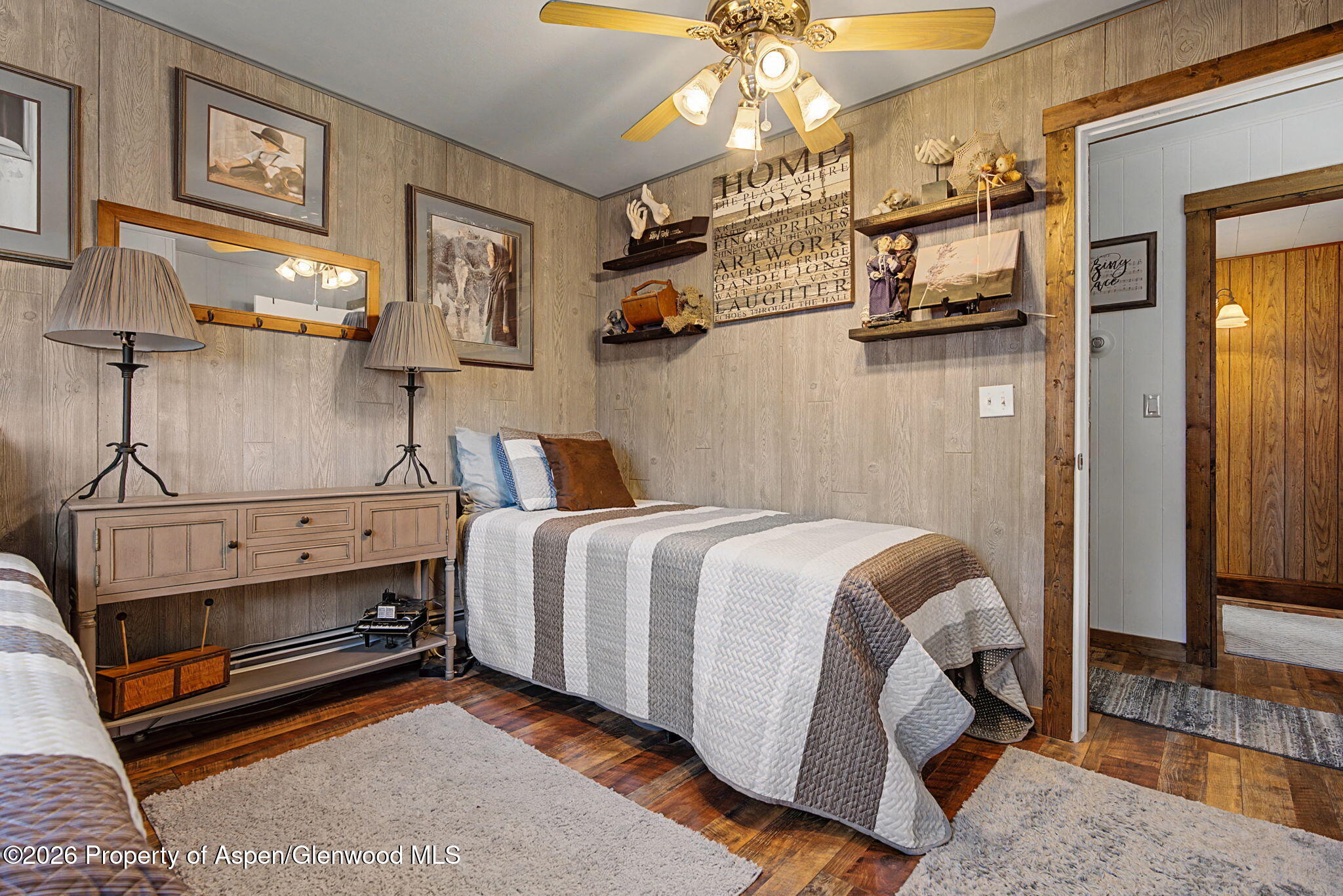 825 Cleveland Street Meeker, CO 81641 - Photo 22 of 41 a spacious bedroom with a bed and a chandelier