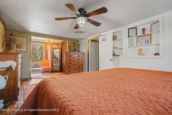 a bedroom with a bed and a dresser