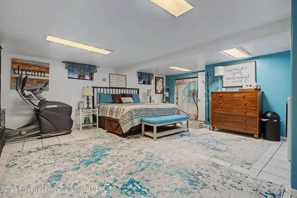 a bedroom with a bed and dresser