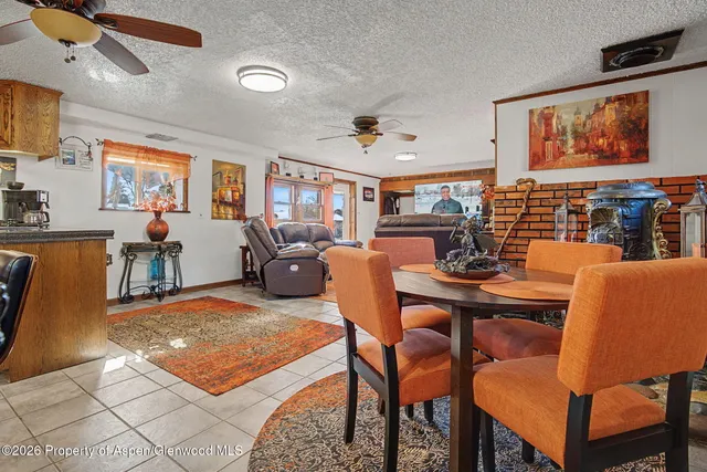 a living room with furniture a flat screen tv and kitchen view