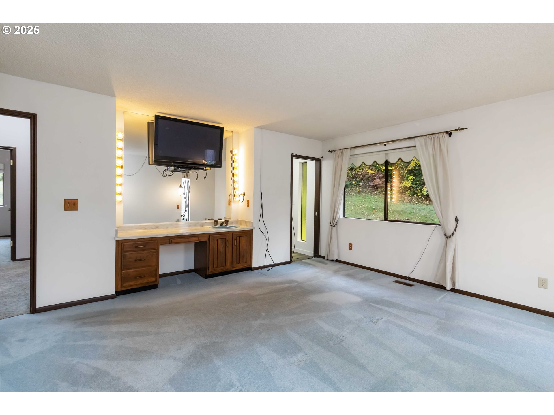 720 Abernathy Creek Road Longview, WA 98632 - Photo 12 of 44 a view of an empty room with a window and a kitchen
