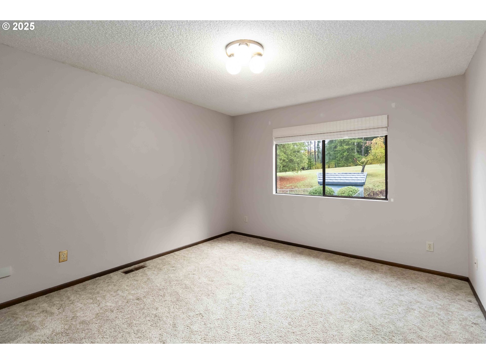 720 Abernathy Creek Road Longview, WA 98632 - Photo 17 of 44 a view of an empty room with a window