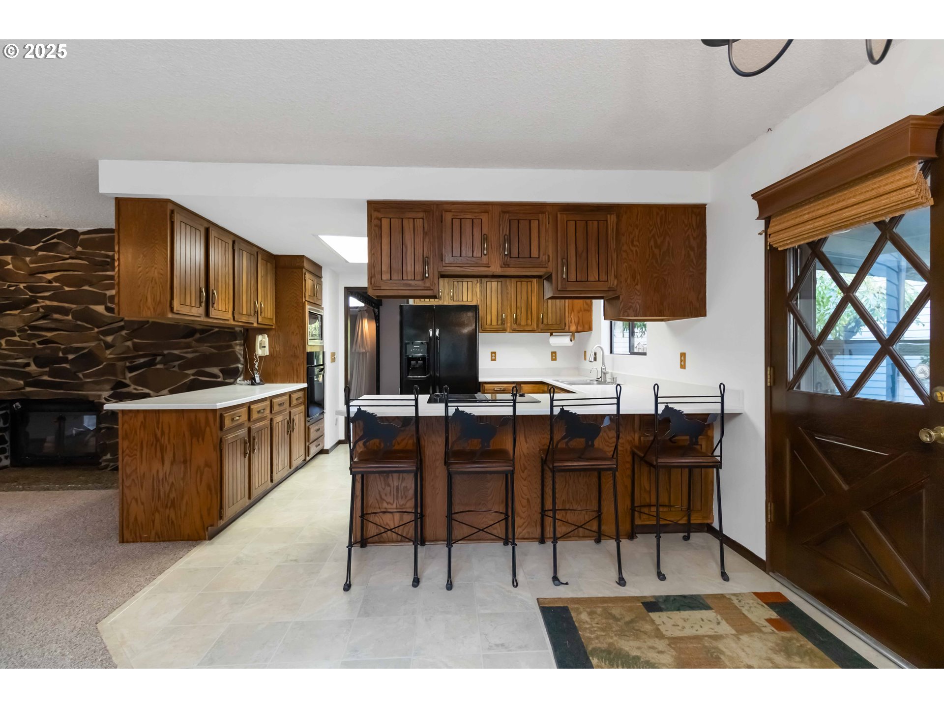720 Abernathy Creek Road Longview, WA 98632 - Photo 7 of 44 a kitchen with a table chairs a sink dishwasher stove and cabinets