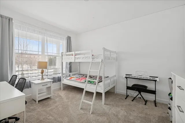 a bedroom with furniture and a large window