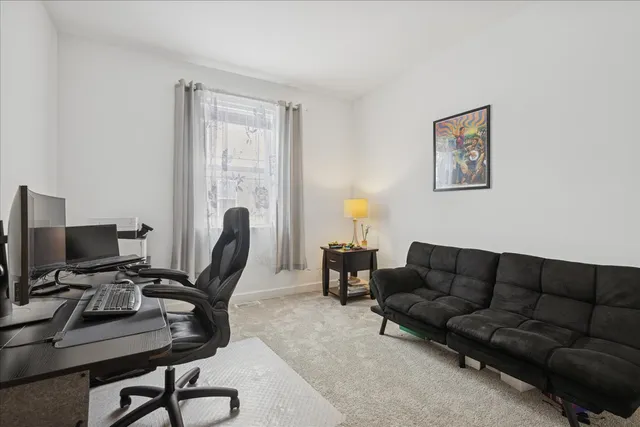a living room with furniture a piano and a flat screen tv