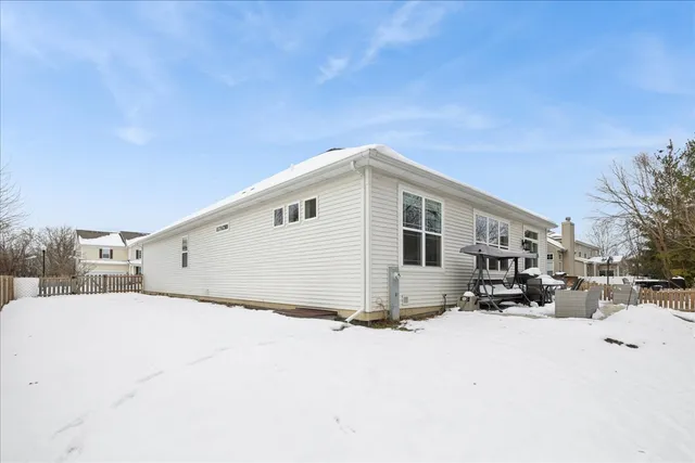 a view of a house with a snow in the background