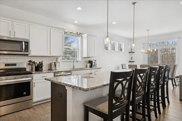 a kitchen with a table chairs stove and microwave
