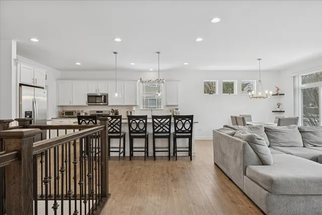 a kitchen with stainless steel appliances kitchen island granite countertop a stove a sink and a refrigerator