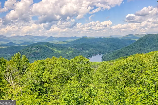 a view of a dining room with furniture water view and mountain view