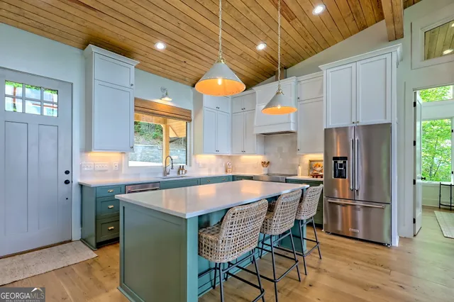 a bathroom with a granite countertop sink and a window