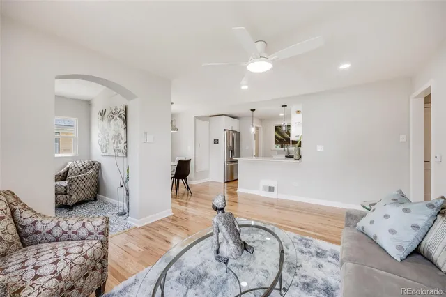 a living room with furniture and wooden floor