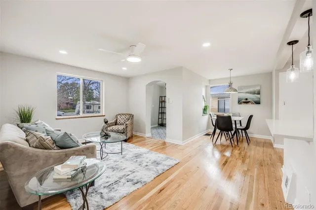 a living room with furniture and a wooden floor