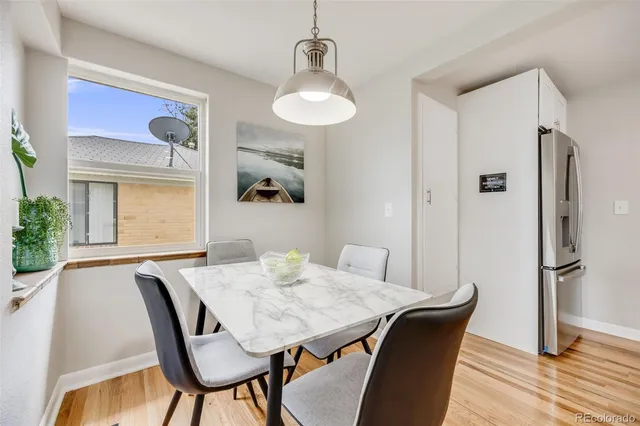 a view of a dining room with furniture and wooden floor