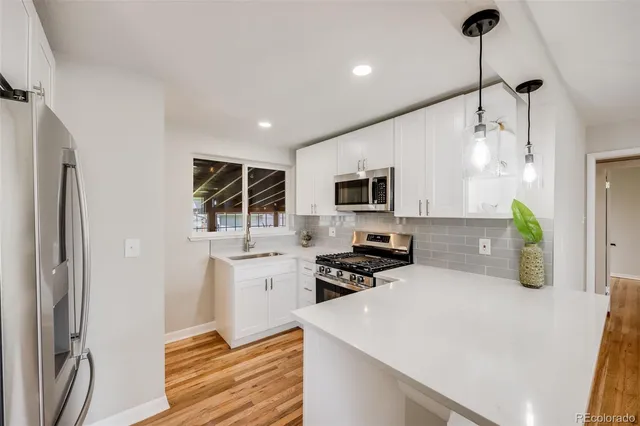 a kitchen with stove cabinets and refrigerator