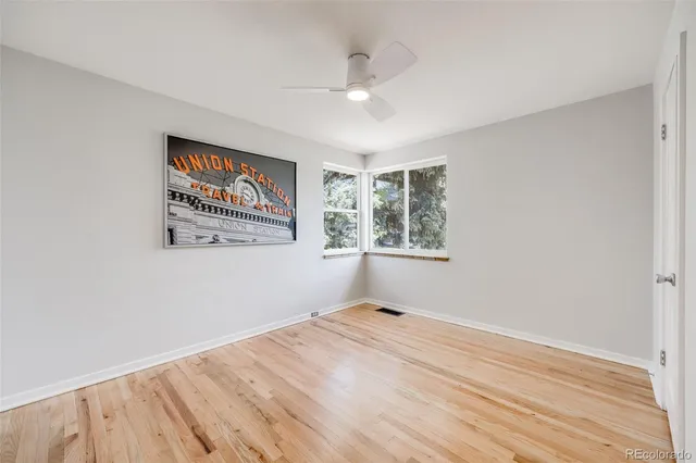 a view of a room with wooden floor and window