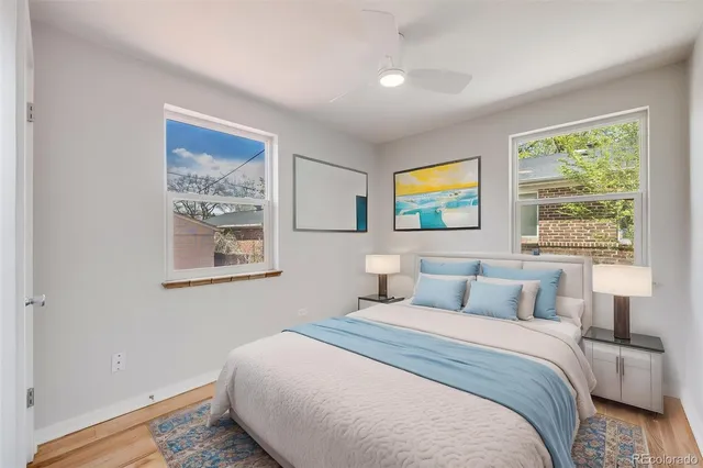 a bedroom with bed and wall painting with wooden floor