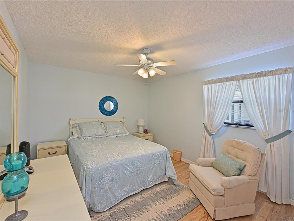 5400 34th Street West, Unit I9 Bradenton, FL 34210 - Photo 21 of 39 a bedroom with a bed and a couch