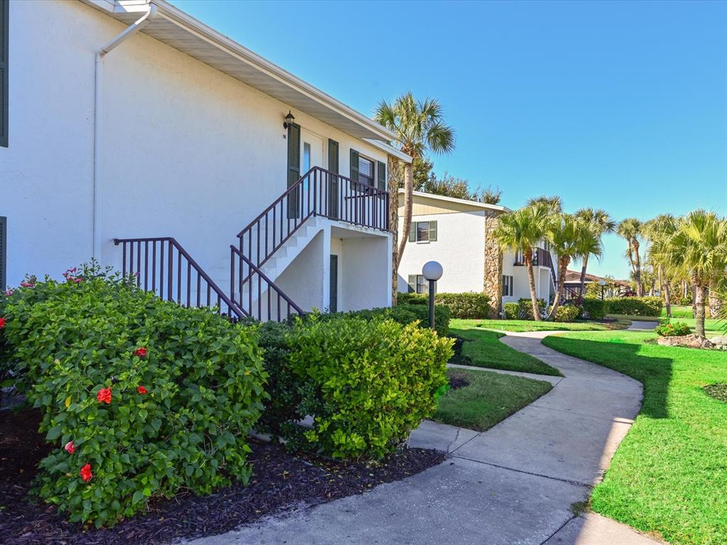 5400 34th Street West, Unit I9 Bradenton, FL 34210 - Photo 3 of 39 a front view of a house with garden