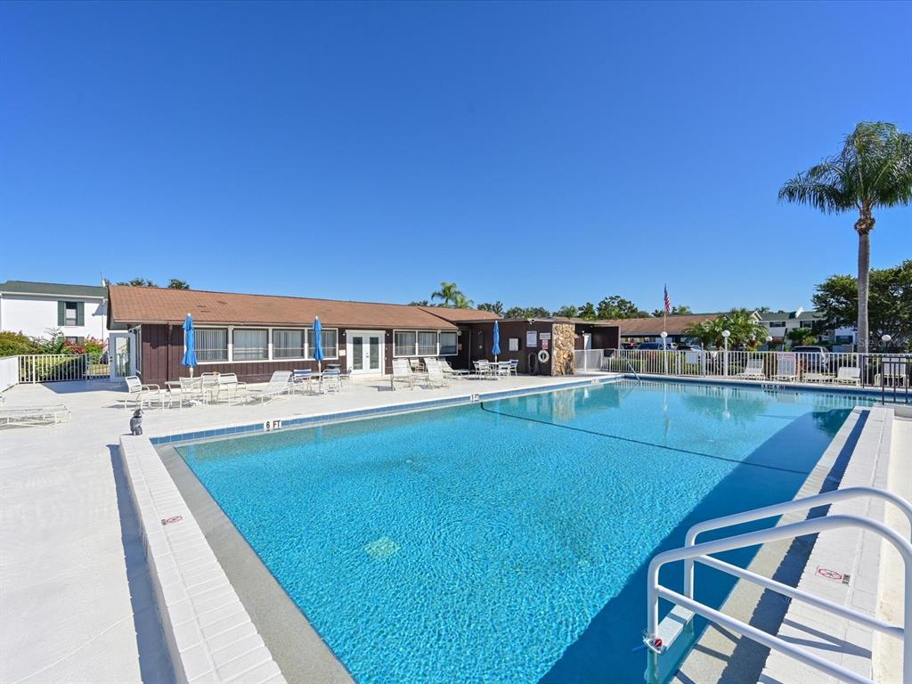 5400 34th Street West, Unit I9 Bradenton, FL 34210 - Photo 33 of 39 a view of a swimming pool with a chairs