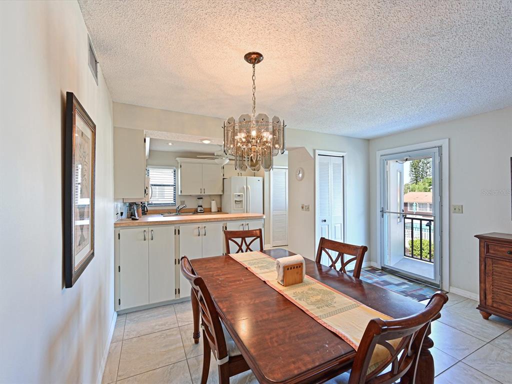 5400 34th Street West, Unit I9 Bradenton, FL 34210 - Photo 6 of 39 a view of a dining room with furniture window and wooden floor