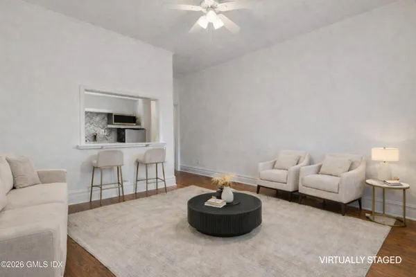 a living room with furniture and a potted plant