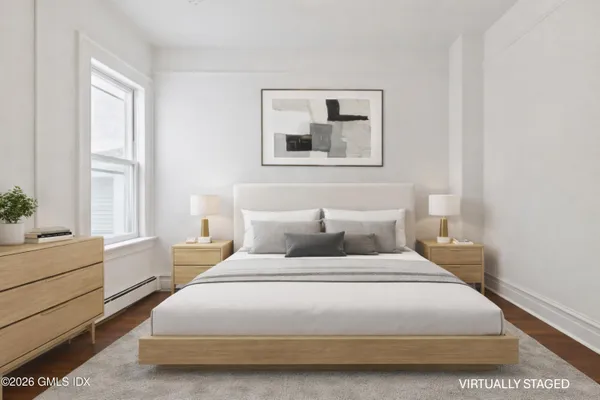 a bedroom with a bed and a window