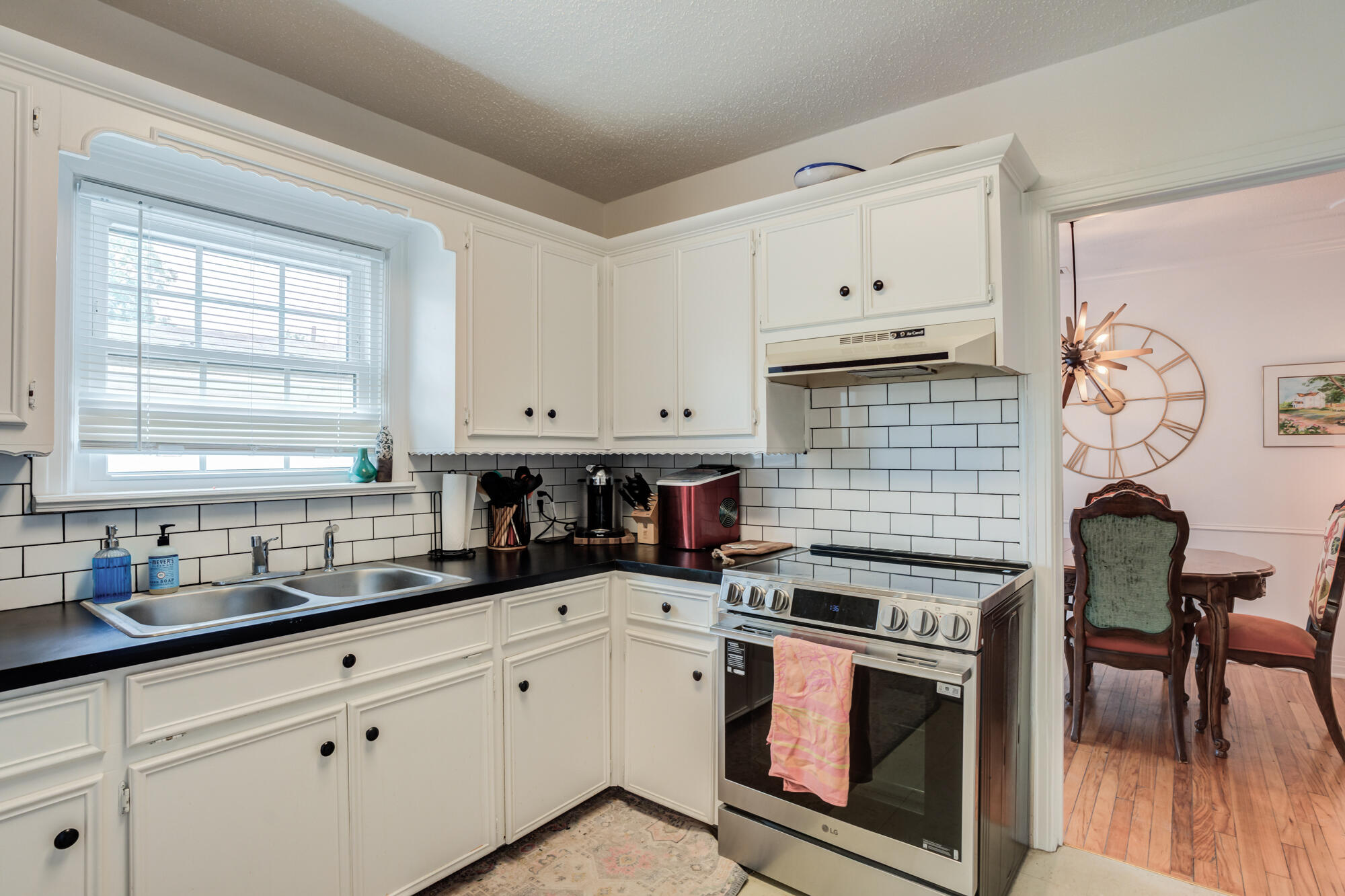 2826 33rd Street Lubbock, TX 79410 - Photo 22 of 33 a kitchen with cabinets and wooden floor