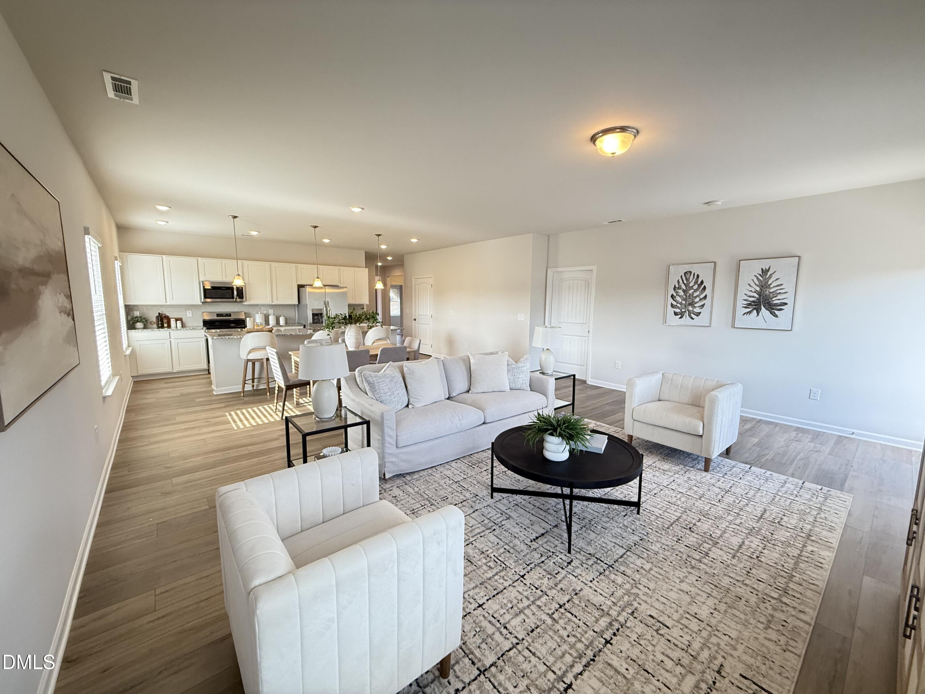 48 Spirit Spgs Road Smithfield, NC 27577 - Photo 11 of 24 a living room with furniture and a wooden floor