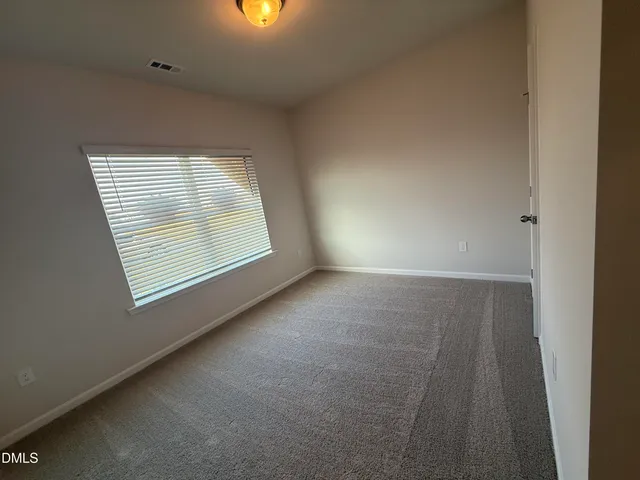 a bathroom with a shower and a glass door
