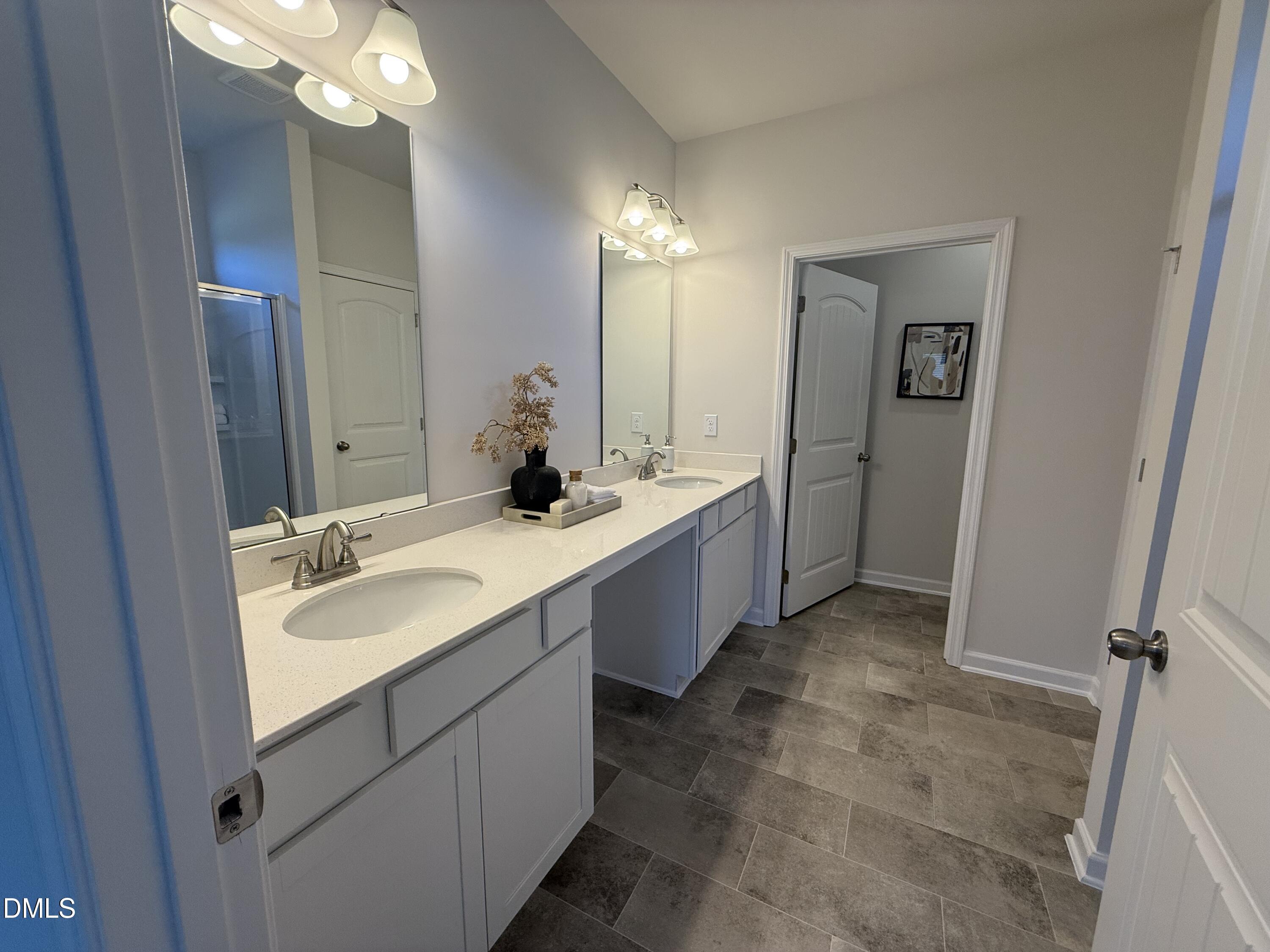 48 Spirit Spgs Road Smithfield, NC 27577 - Photo 16 of 24 a spacious bathroom with a double vanity sink mirror and shower