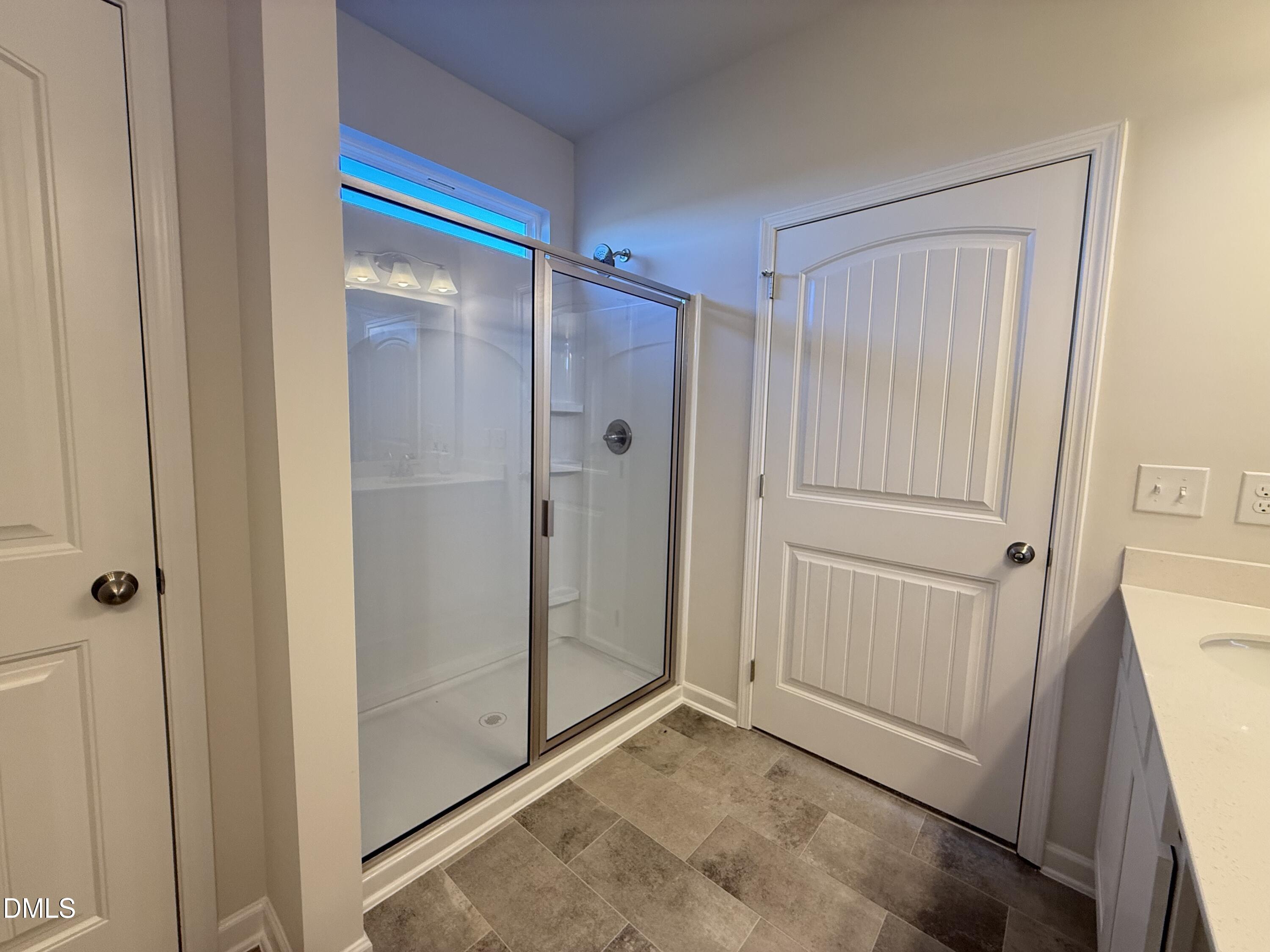 48 Spirit Spgs Road Smithfield, NC 27577 - Photo 17 of 24 a bathroom with a shower and a glass door